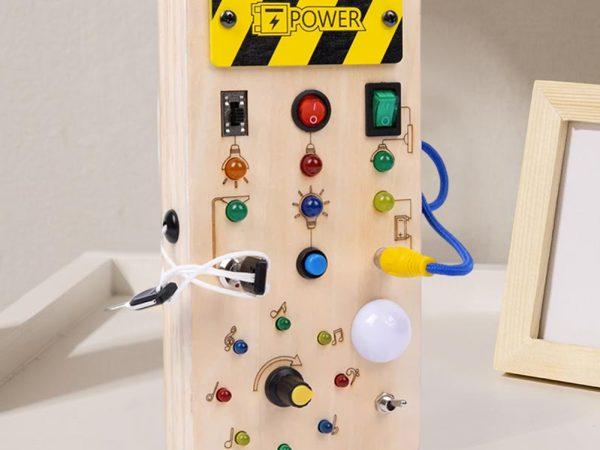 small busy board with switches and lights
